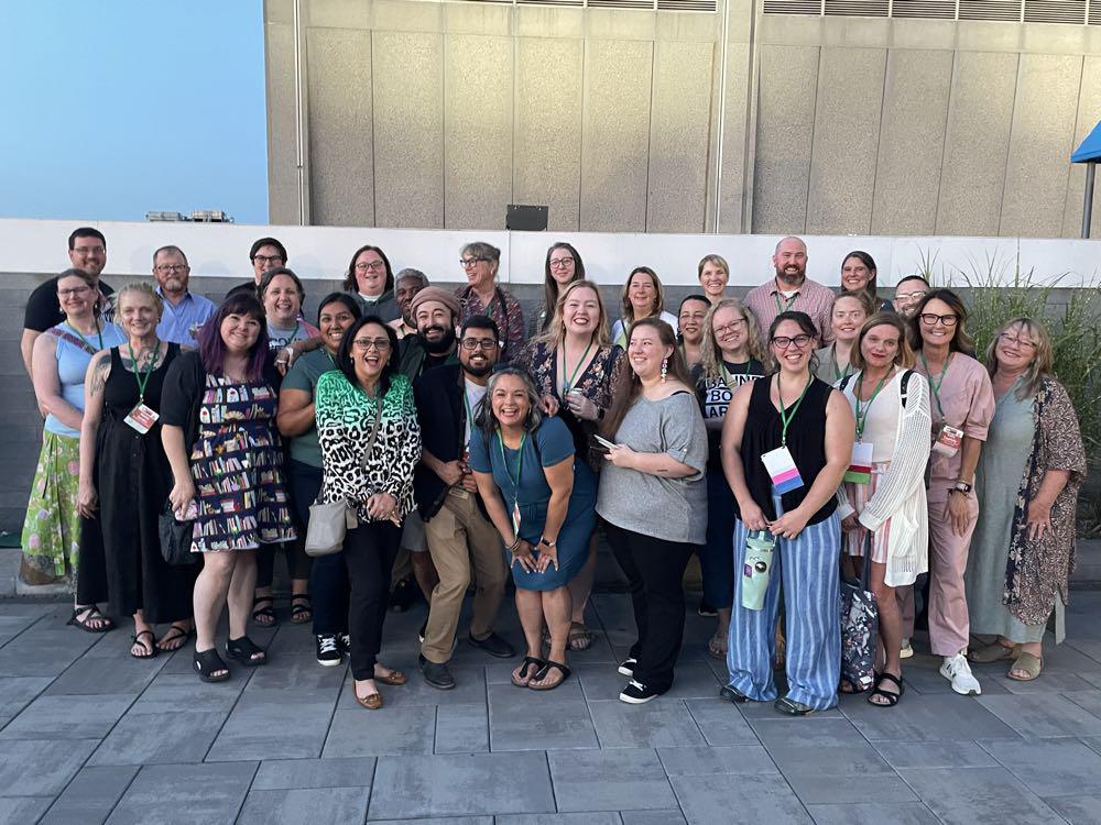 Group of ARSL conference attendees posing on a roof and smiling.