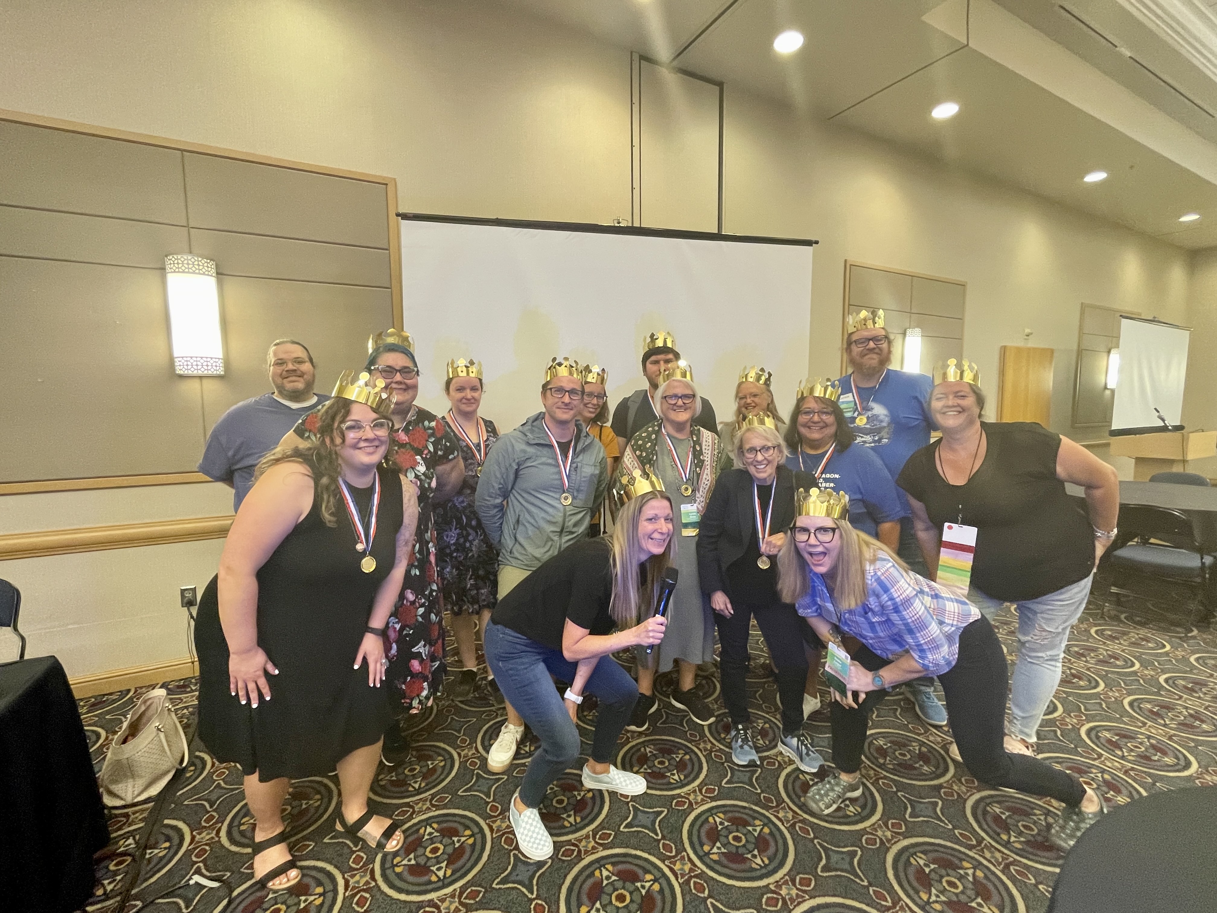 Group of ARSL conference attendees wearing golden crowns and smiling.
