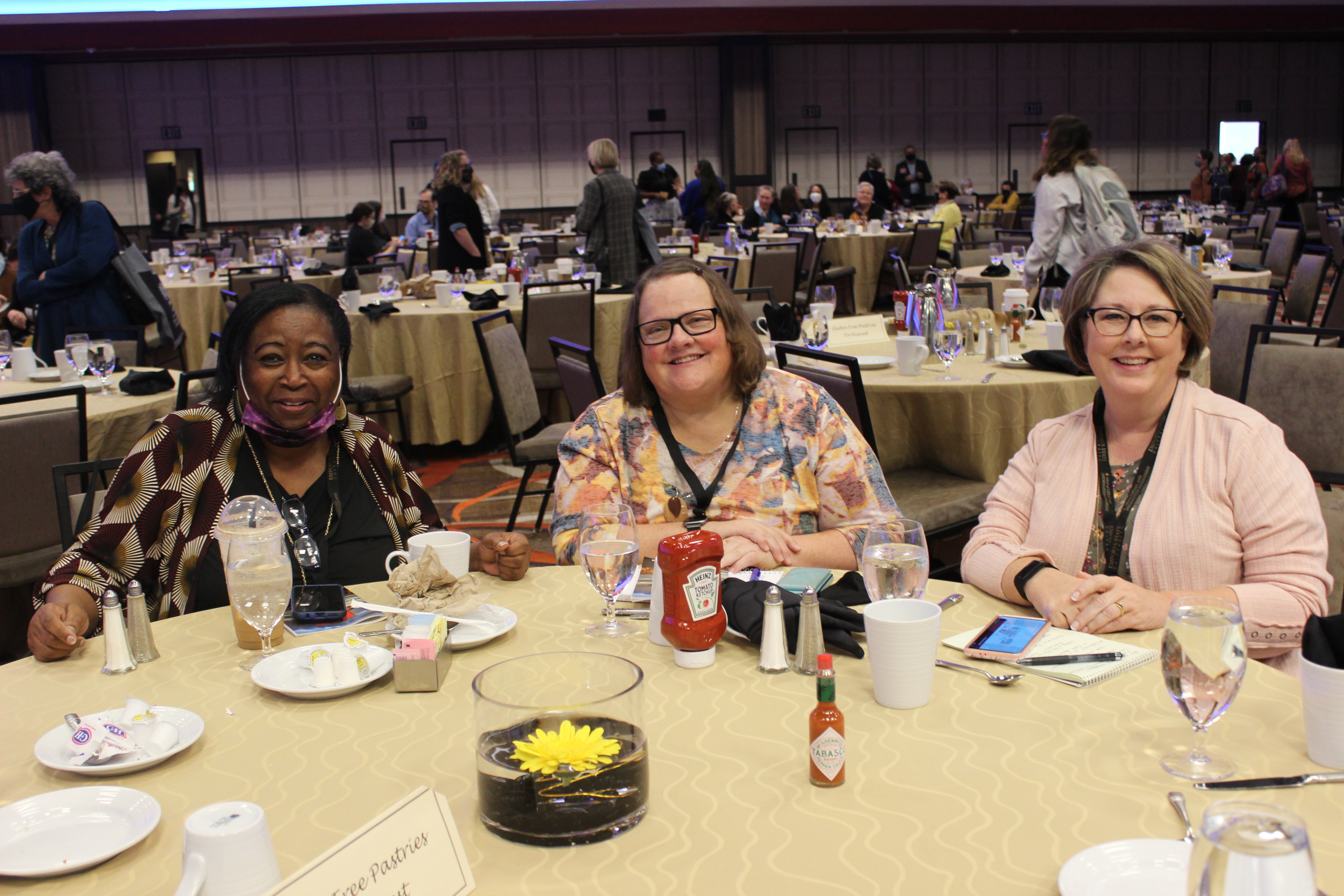 Three ARSL conference attendees at a lunch table.
