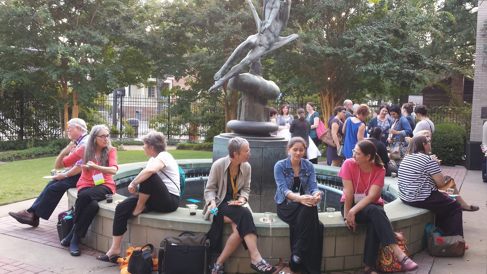 ARSL conference attendees sitting around a fountain and talking.