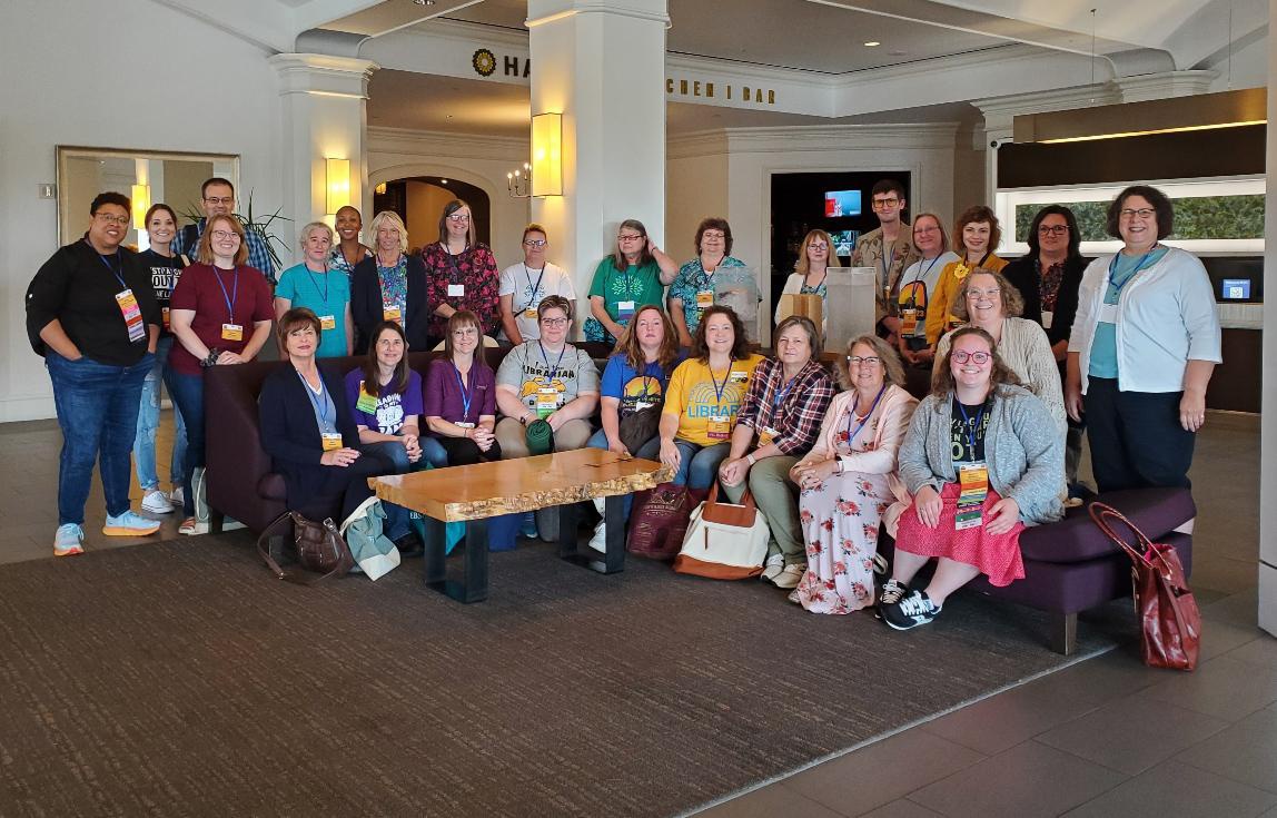 Large group of ARSL conference attendees posed in a hotel lobby.