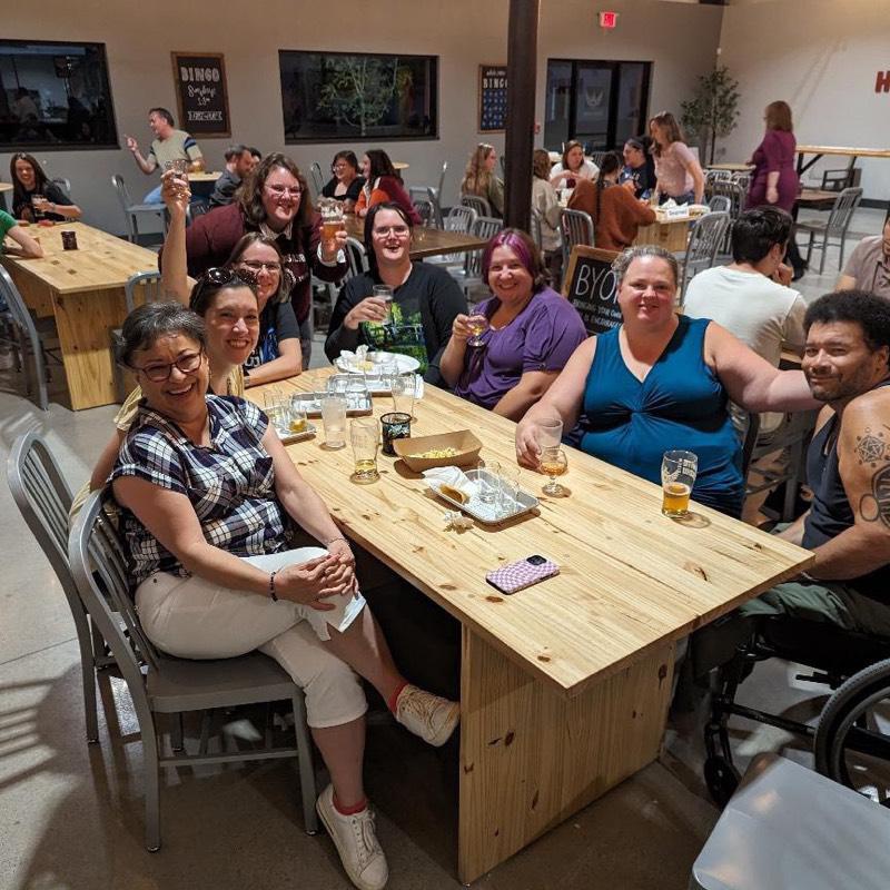 ARSL conference attendees at a bar with drinks.
