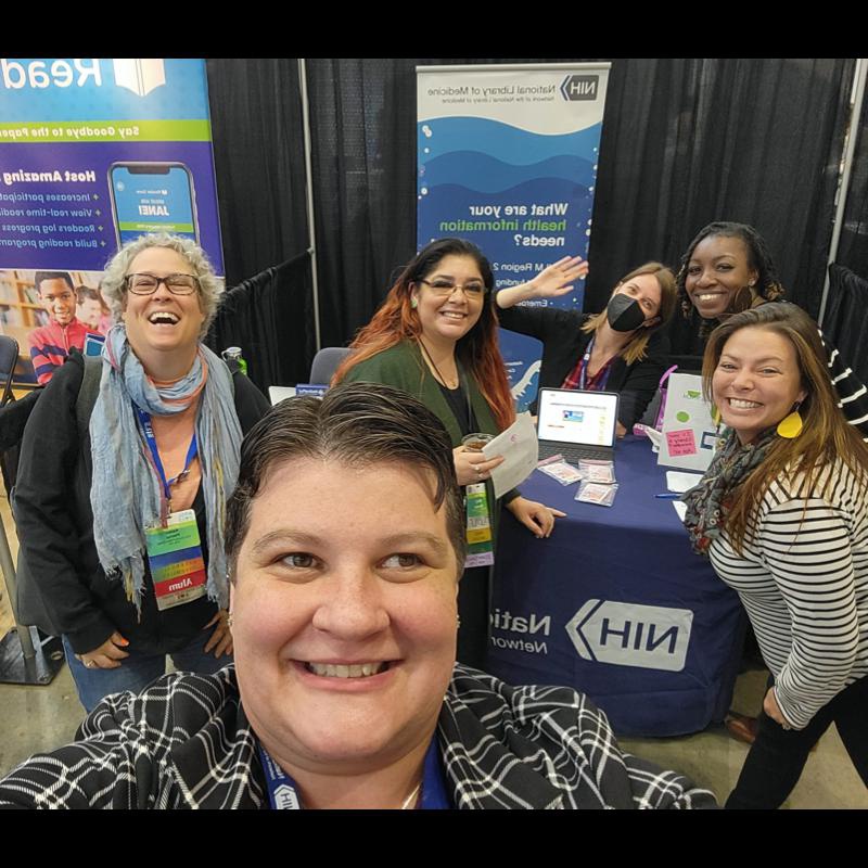 Attendee selfie in front of an ARSL conference booth.